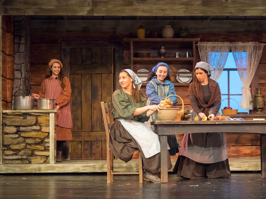 Woman with sunglasses walking down runway
